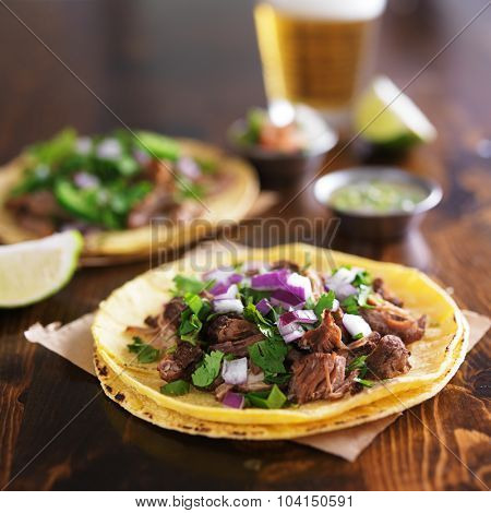 authentic mexican street tacos with barbacoa beef on yellow corn tortilla