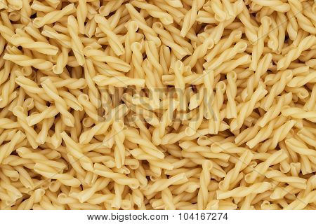 dry uncooked gemelli pasta texture background