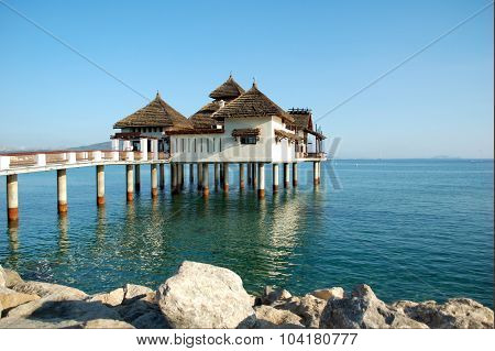 A public building with iron columns inside the sea
