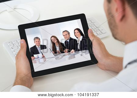 Businessman Videoconferencing With Digital Tablet