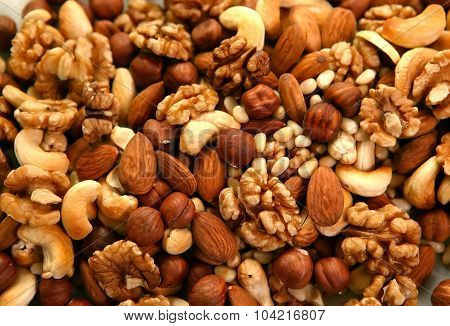 Peeled nuts in bulk as background: walnut and almonds, cashews