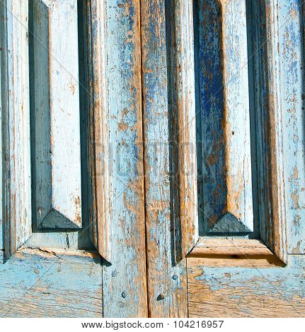 Dirty Stripped Paint In The Blue Wood Door And Rusty Nail