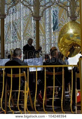 Conductor directs the orchestra on a sounding board