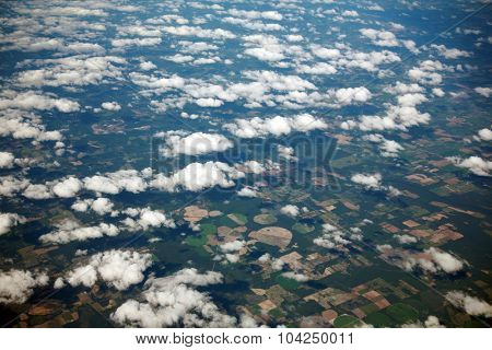 A unique view of Florida USA as seen from high above the clouds, through the window of a Jet Airplane. Florida is known for Alligators, Swamps, Sandy Beaches and is an international vacation spot