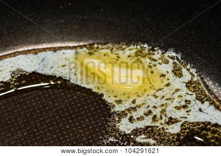 Macro Of Piece Of Butter Melting In Pan