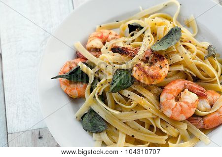 Fettuccini with shrimps and basil leaves
