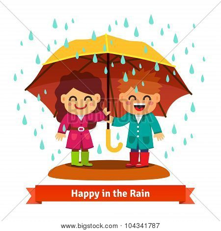 Boy and girl standing in the rain under umbrella