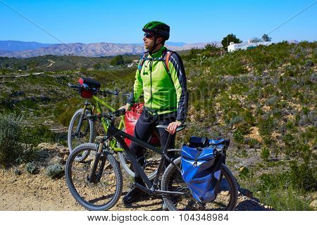 cycling tourist MTB cyclist in Pedralba Valencia with paniers and saddlebag Spain