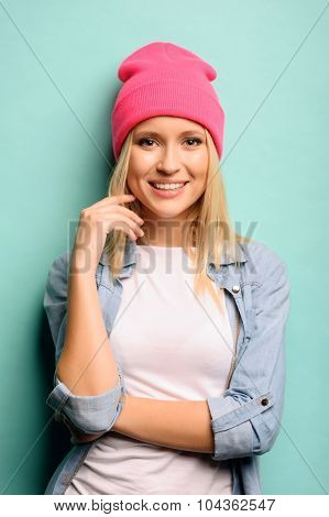 Cheerful girl standing on blue background