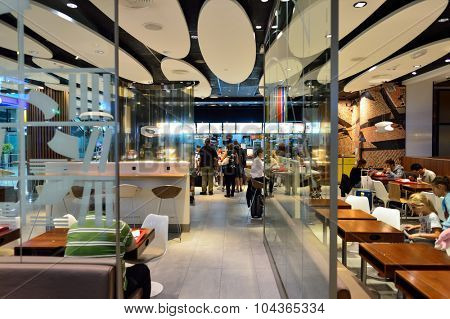 DUBAI, UAE - SEPTEMBER 08, 2015: McDonald's restaurant in Dubai Airport. There are a lot of restaurants, bars, cafes and shops in Dubai International Airport. Almost all of them are open 24 hours.