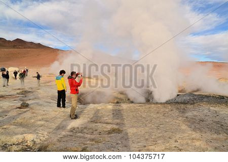 Tourists at a geysir in Southwestern Bolivia near Uyuni