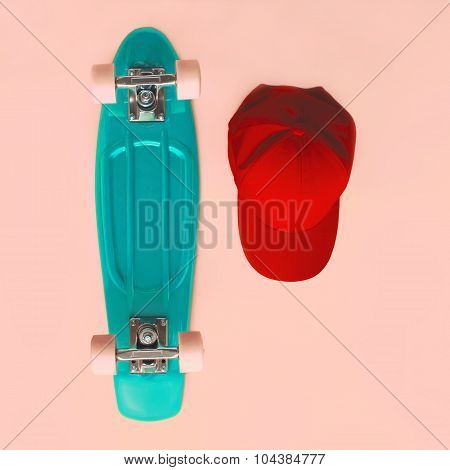 Fashion Set. Skateboard And Baseball Cap On Pink Background, Top View. Vintage Colorful Photo