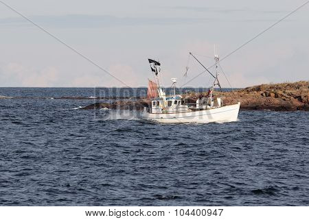 Small Fishingboat In Front Of An Island