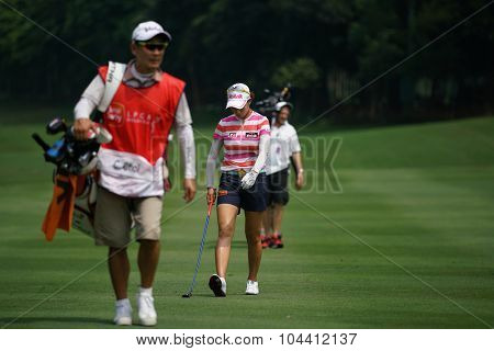 KUALA LUMPUR, MALAYSIA - OCTOBER 09, 2015: LPGA golfers and caddy walk on the fairway of the Kuala Lumpur Golf & Country Club during the 2015 Sime Darby LPGA Malaysia golf tournament.