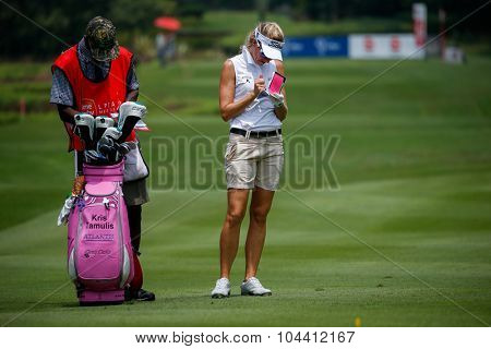 KUALA LUMPUR, MALAYSIA - OCTOBER 09, 2015: USA's Kris Tamulis takes down notes on the sixth hole fairway of the KL Golf & Country Club at the 2015 Sime Darby LPGA Malaysia golf tournament.