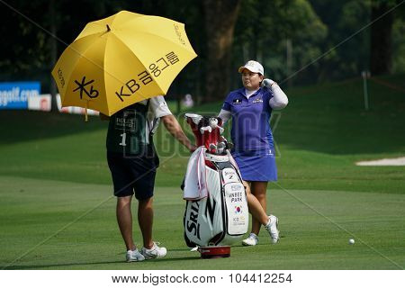 KUALA LUMPUR, MALAYSIA - OCTOBER 09, 2015: South Korea's Inbee Park discusses with her caddy on the fairway of the KL Golf & Country Club at the 2015 Sime Darby LPGA Malaysia golf tournament.