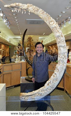 Artist Eddie Lee Poses With His Woolly Mammoth Sculptor