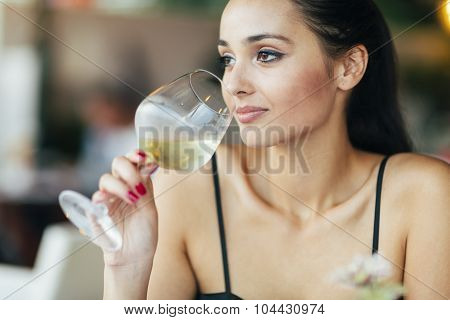 Attractive Woman Tasting White Wine