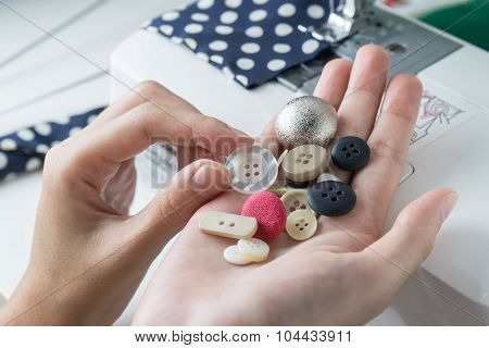 Choose Buttons In Woman Hands , Close Up