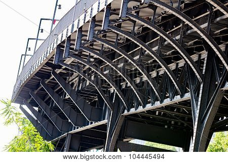 Urban gray metal bridge on sunny day