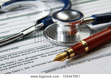 Stethoscope on medical billing statement on table, all text is anonymous