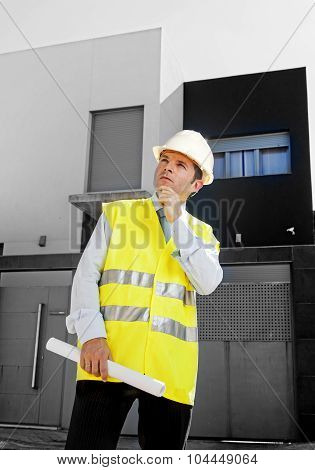 Young Attractive Architect Worker Supervising Building Blueprints Outdoors Wearing Construction Helm