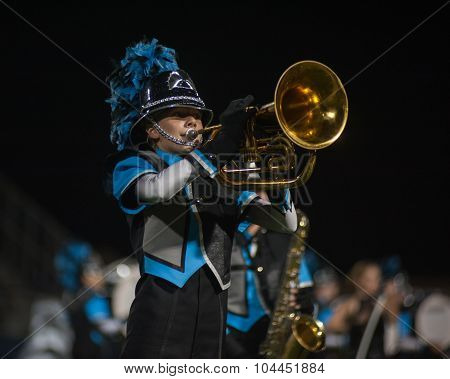 Marching band putting on show at football game.