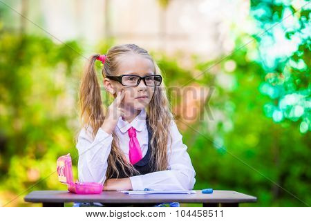 Adorable little school girl outdoor. Back to school.