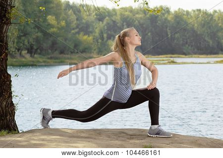 Beautiful Young Blonde Woman With Athletic Body Doing Stretching Exercise Outdoors