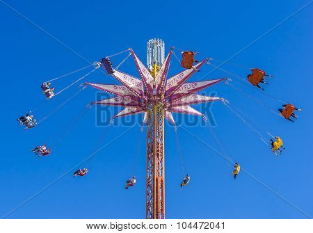 A chair swing ride shot in blue sky