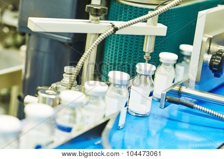 pharmaceutical industry. Production line machine conveyor at factory with bottles
