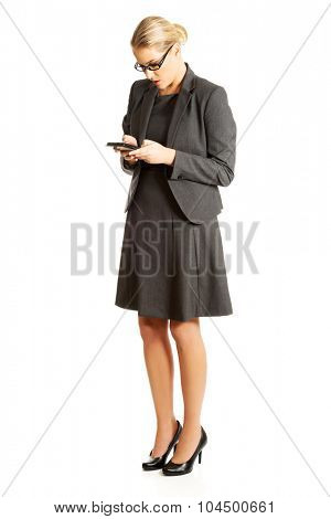 Beautiful businesswoman sending a message