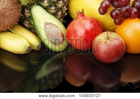 Cropped Shot Of Fruits-grapes,pomegranate,avocado On Black With Reflection