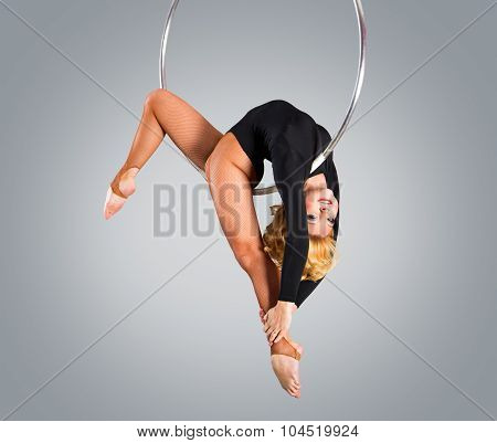 Plastic Beautiful Girl Gymnast On Acrobatic Circus Ring In Flesh-colored Suit. Aerial Ring.