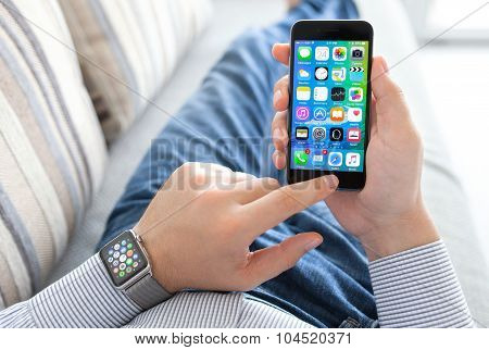 Man Hand With Apple Watch Holding Iphone