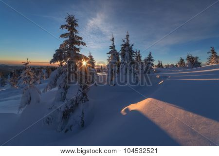 Fantastic orange evening landscape glowing by sunlight. Dramatic wintry scene with snowy trees. Kukul ridge, Carpathians, Ukraine, Europe. Merry Christmas!