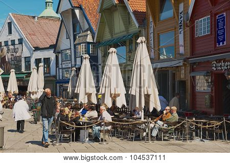 People relax in a street cafe in downtown Stavanger, Norway.