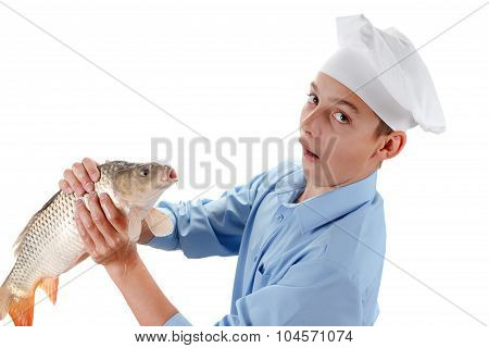 Young Chef Holding A Fish Carp On White Background