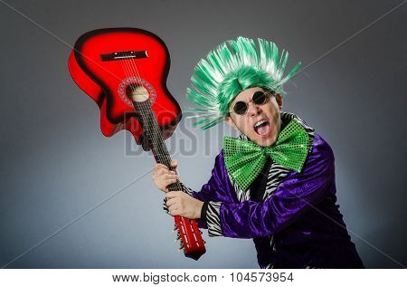 Funny man playing guitar in musical concept