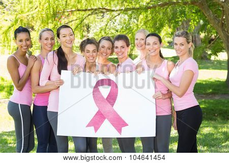 Breast cancer awareness message against smiling women in pink for breast cancer awareness