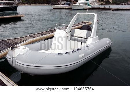 White Inflatable Rubber Speed Motor Boat At The Berth