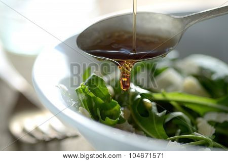 Poring Oil On To Green Salad