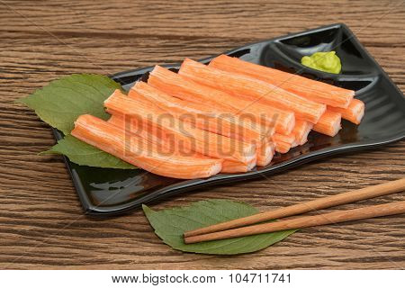 Imitation Crab Stick  In Plate On Wooden  Background