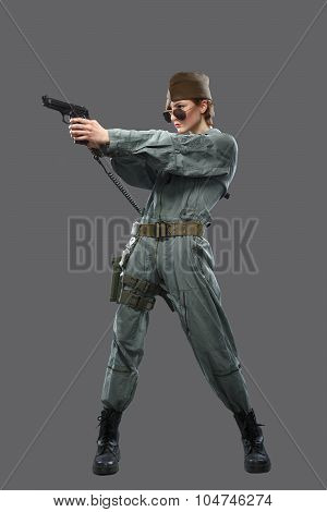 A Girl Dressed As A Helicopter Pilot With A Gun In His Hand.