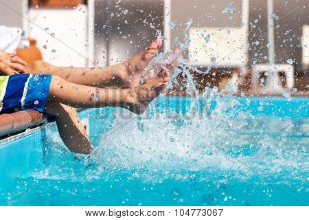 Boys Legs Splashing Water In Pool