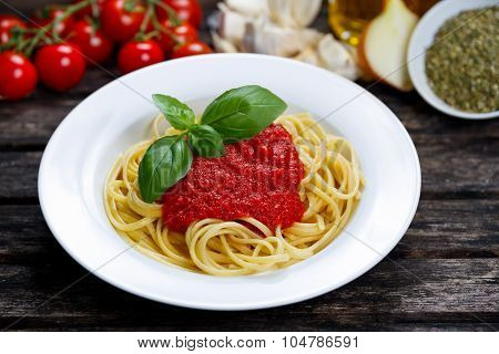 Spaghetti With Marinara Sauce And Basil Leaves On Top, Decorated With Vegetables, Olive Oil, Italian