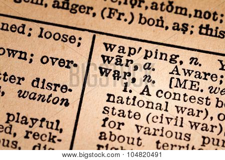 Close-up Of An Opened Dictionary Showing The Word War