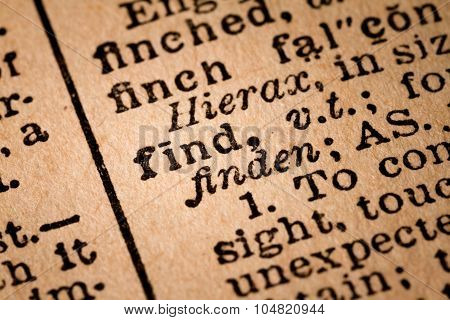Close-up Of An Opened Dictionary Showing The Word Find