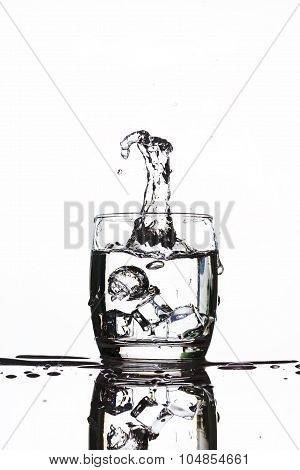Ice Dropping Into A Glass Of Water Making Strange Shape Water