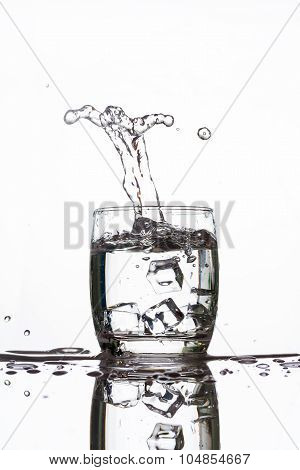 Ice Dropping Into A Glass Of Water Making Strange Shape Water